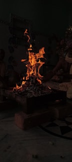 A warm, rustic fire pit surrounded by traditional Turkish cooking pots with glowing embers.