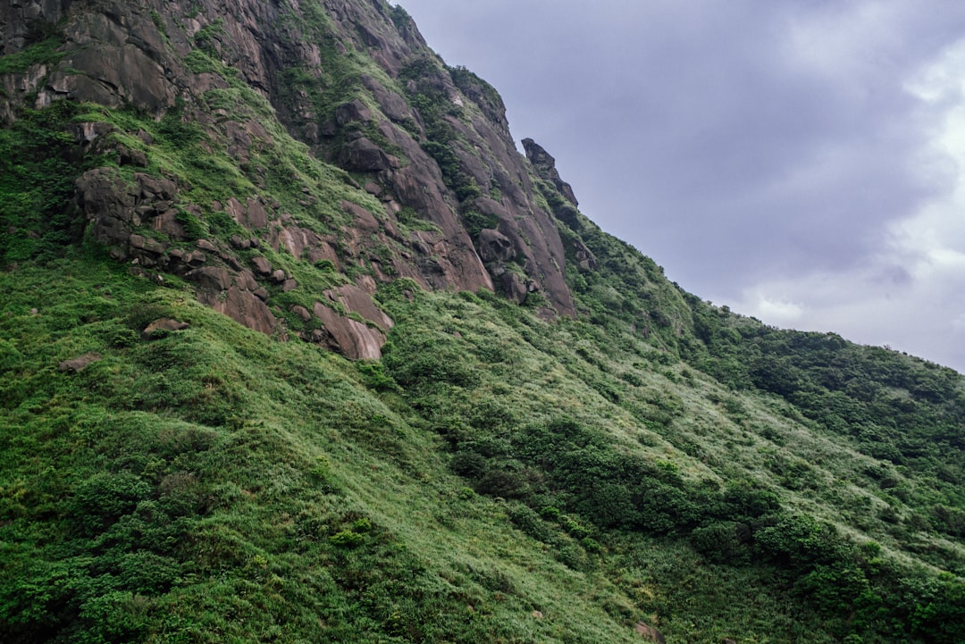 green and gray mountain under white clouds during daytime