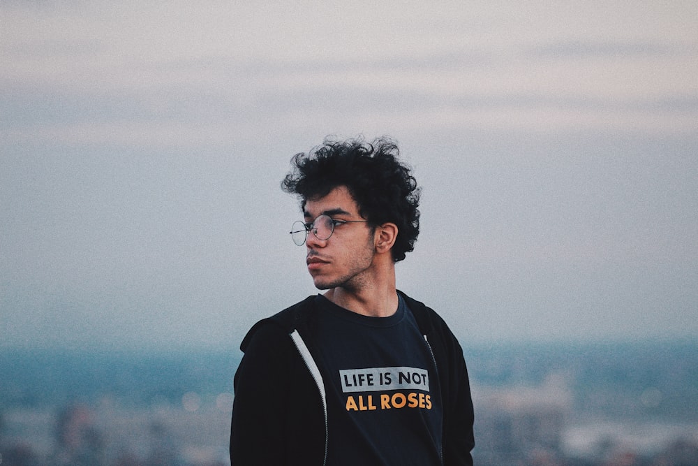 man in black and white adidas crew neck shirt