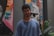 man in blue crew neck shirt standing near wall
