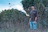 man in black crew neck t-shirt standing on green grass field during daytime