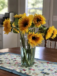 Bright sunflowers arranged in a cheerful bouquet on a wooden table