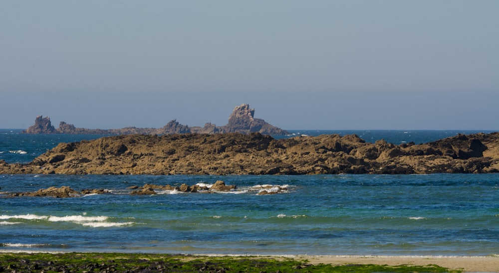 brown rock formation on sea water during daytime