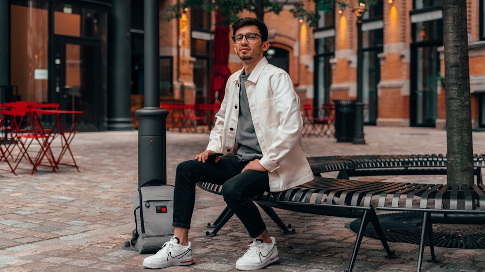 man in white button up shirt sitting on bench