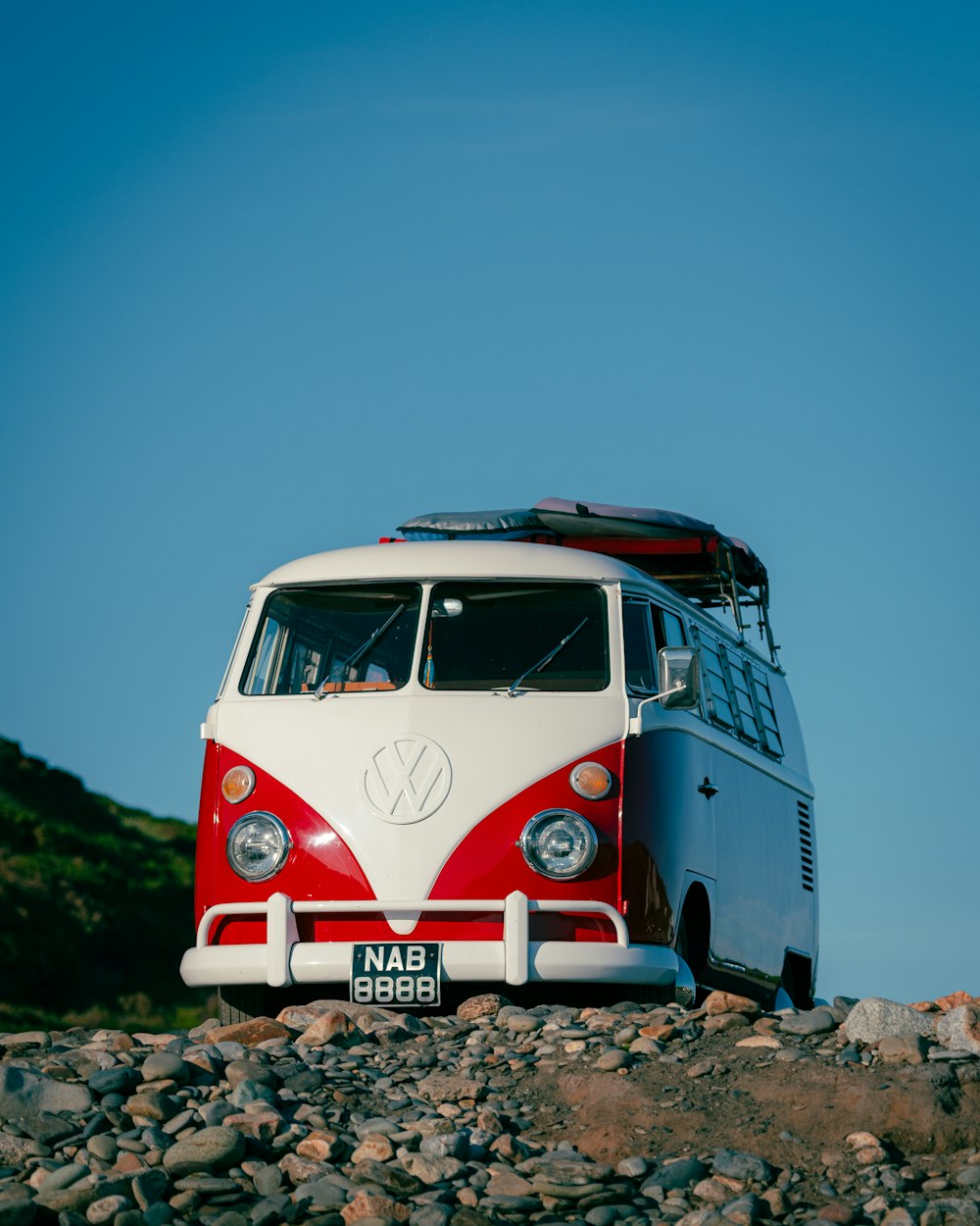 white and red volkswagen t-1 van on gray concrete road during daytime