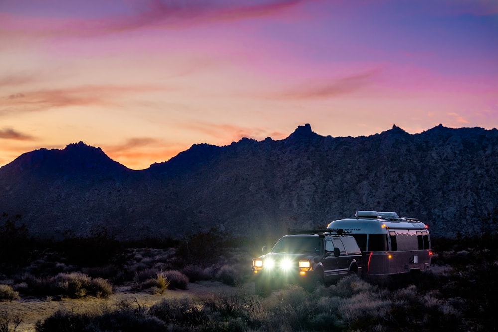 white suv on green grass field during sunset