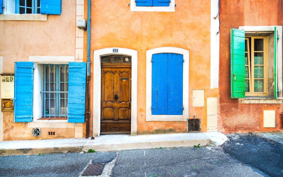 blue wooden door on brown concrete building