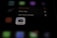 A blurred image with a focus on a smartphone screen displaying an app management menu. The options visible include 'Remove App', 'Share App', and 'Edit Home Screen'. An icon for a Canon camera app is also prominent.