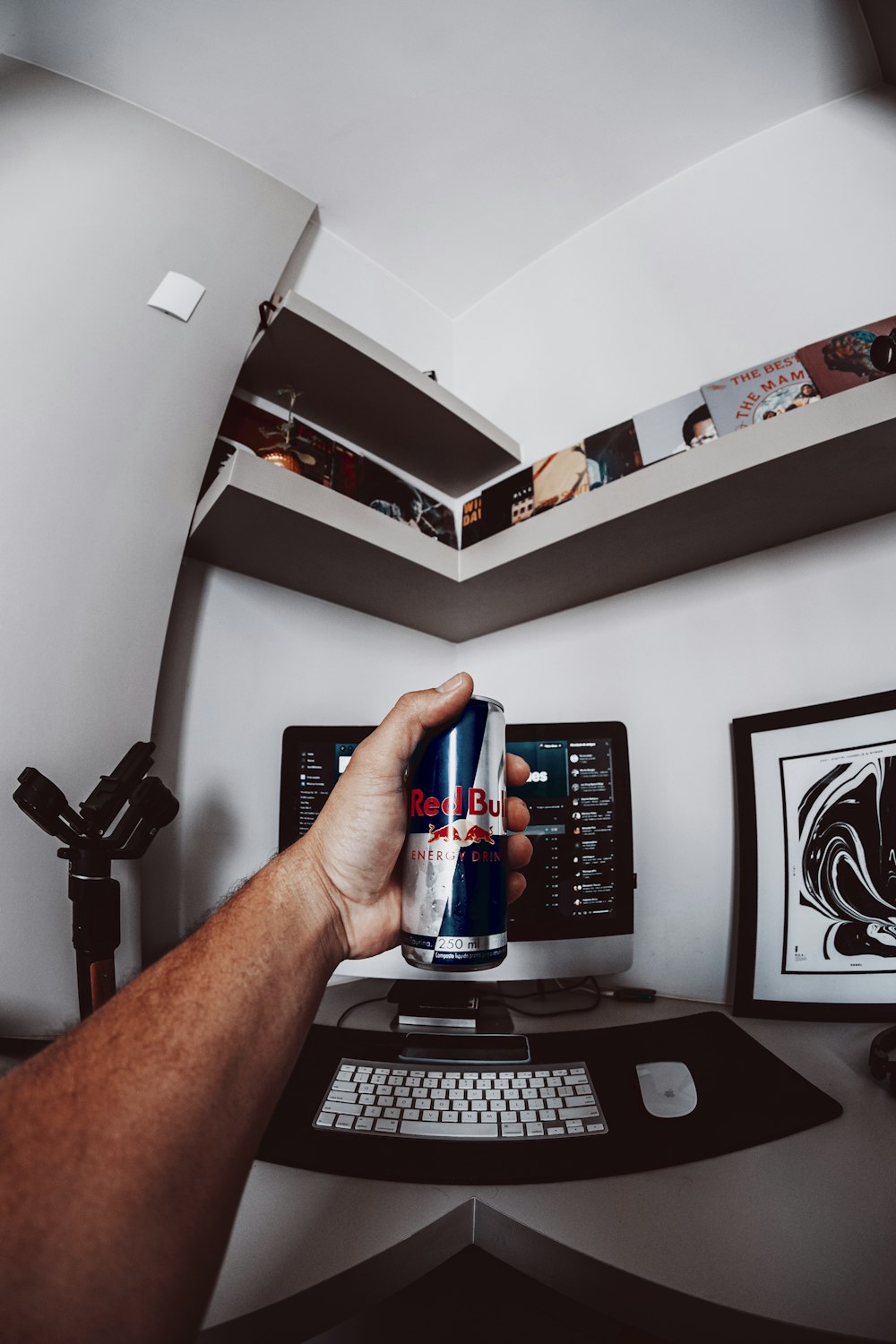 person holding pepsi can near black computer keyboard