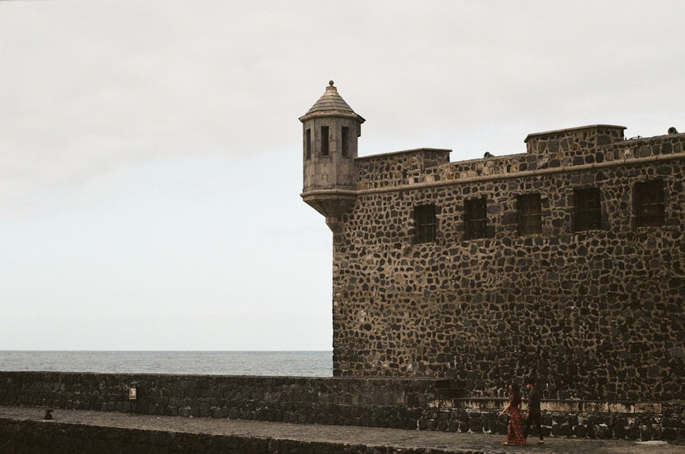 brown concrete building near sea during daytime