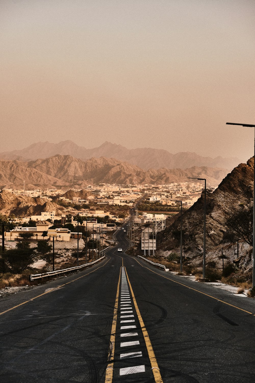 black asphalt road in the middle of city during daytime