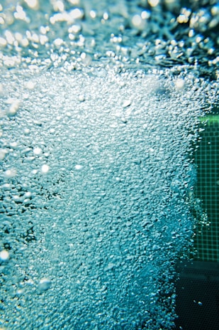 Close-up of a molecular hydrogen therapy machine in use, bubbles rising in water.