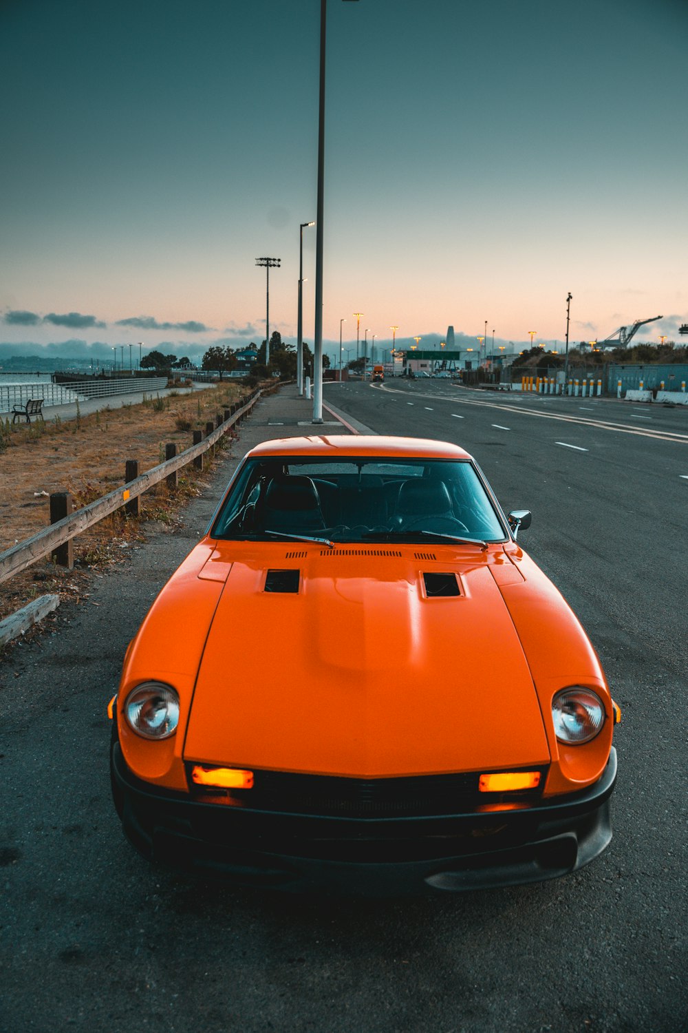 orange car on the road during daytime