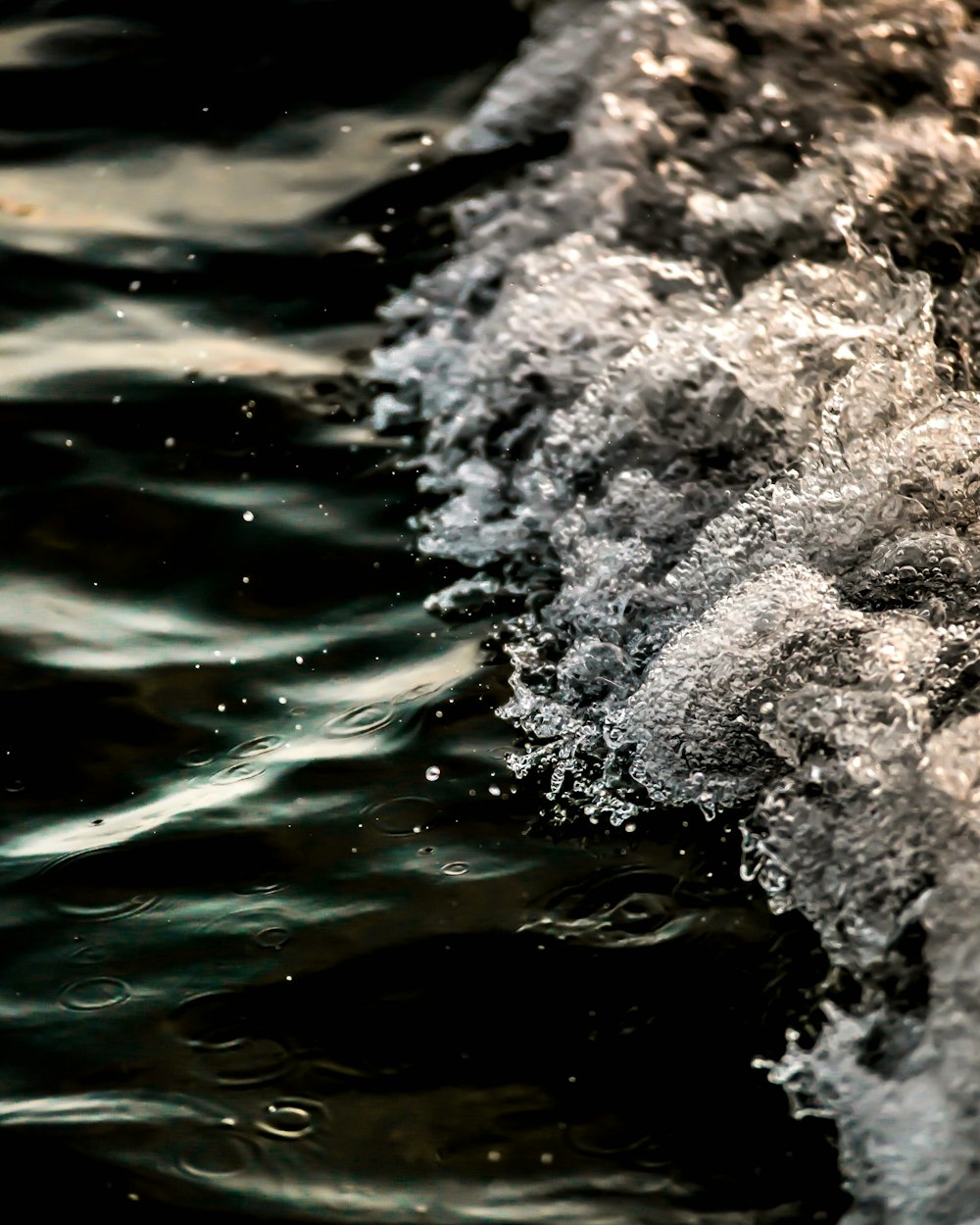 water waves on black rock