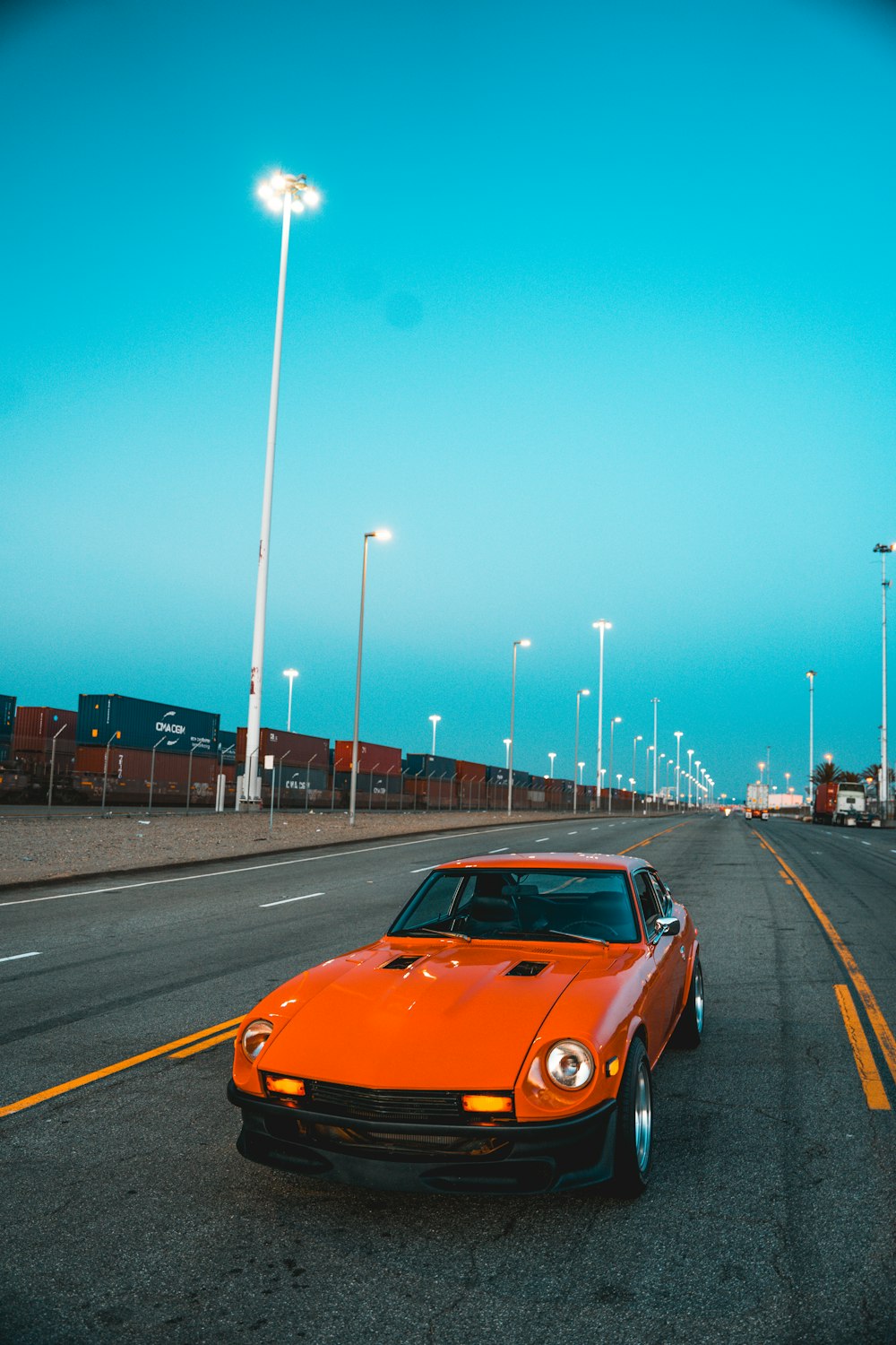 orange car on road during night time