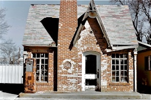 brown brick building with white wooden door