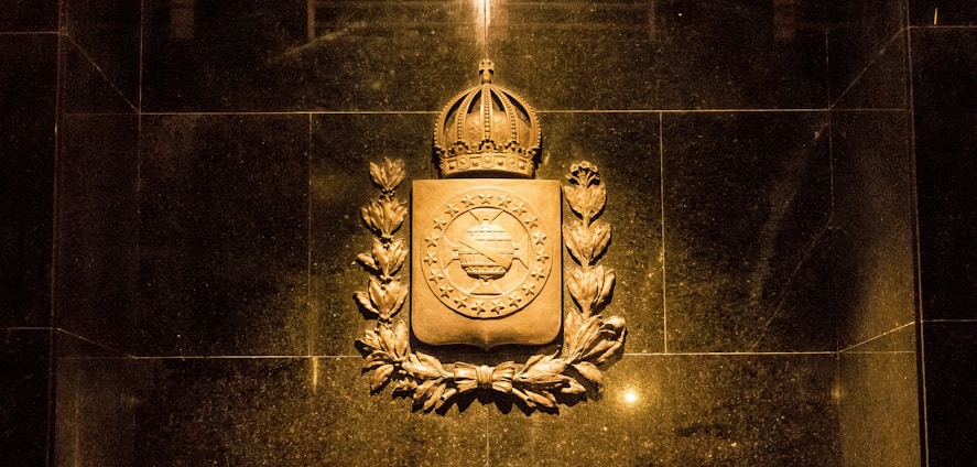 A sturdy brick wall with a golden crown resting on top, symbolizing strength and premium property investment.