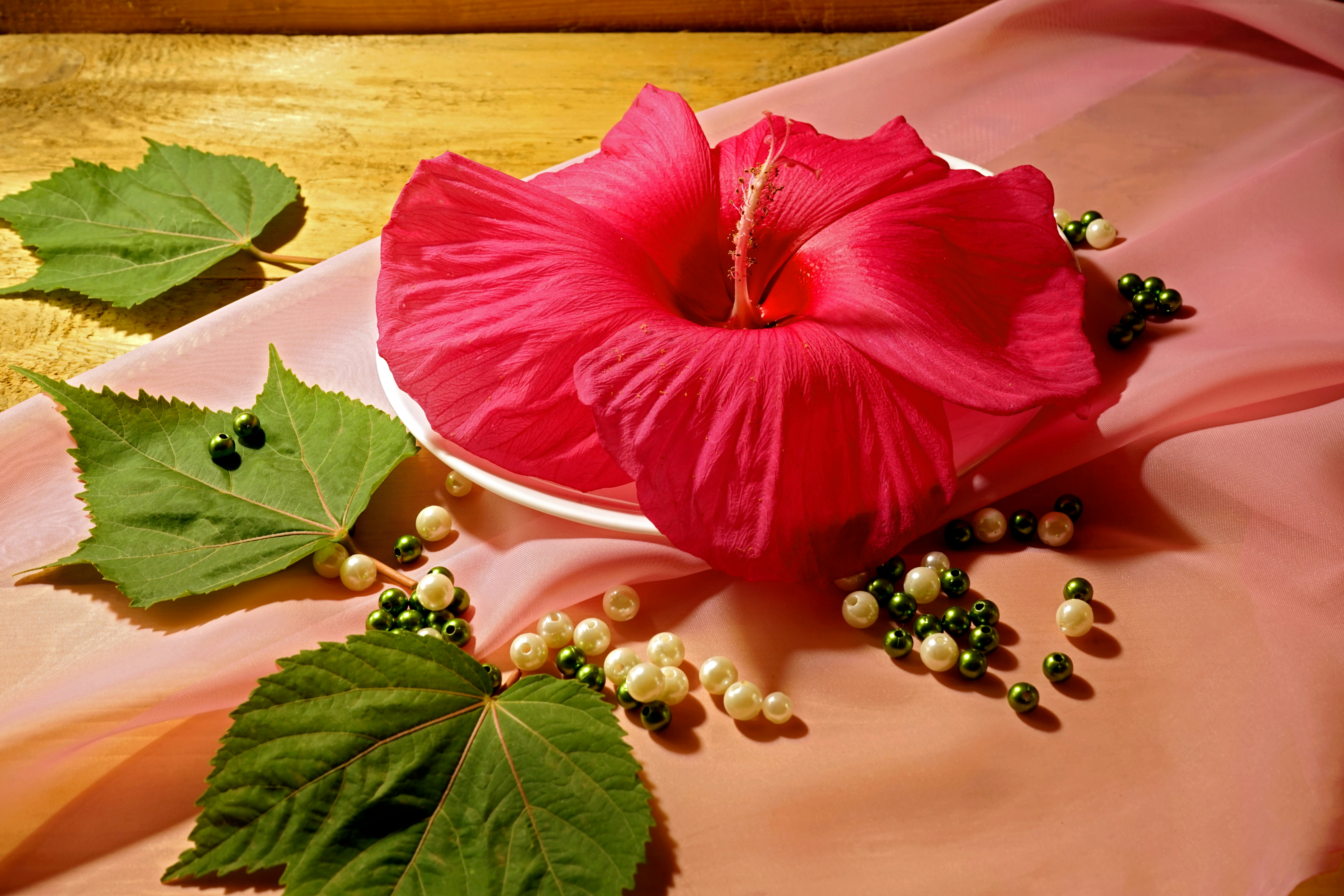 Pink and green hibiscus floral scatter print on ivory background