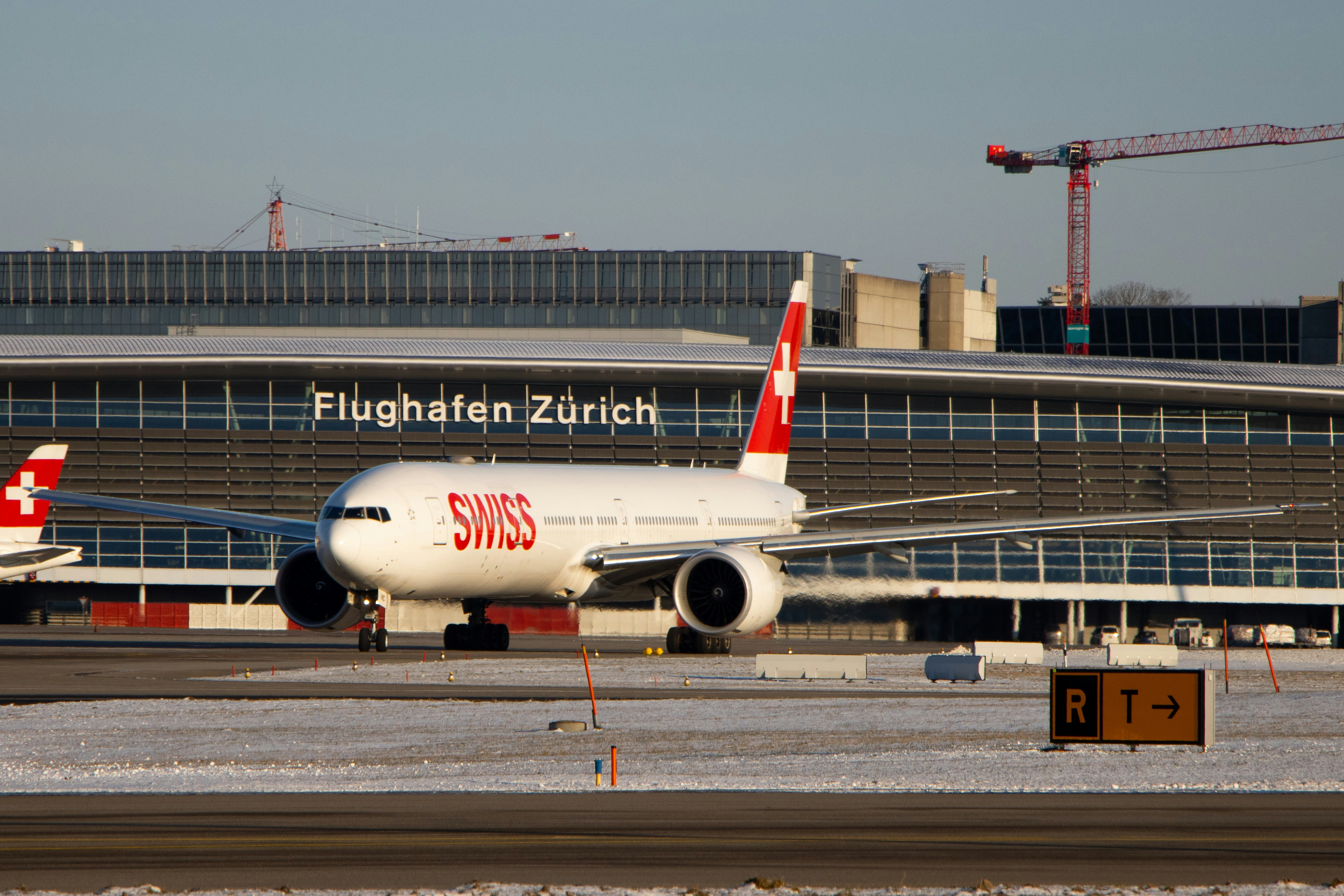 white and red passenger plane on airport during daytime, 