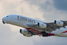 white and red passenger plane in the sky