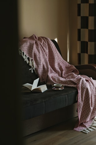 man in black shirt reading book on black couch