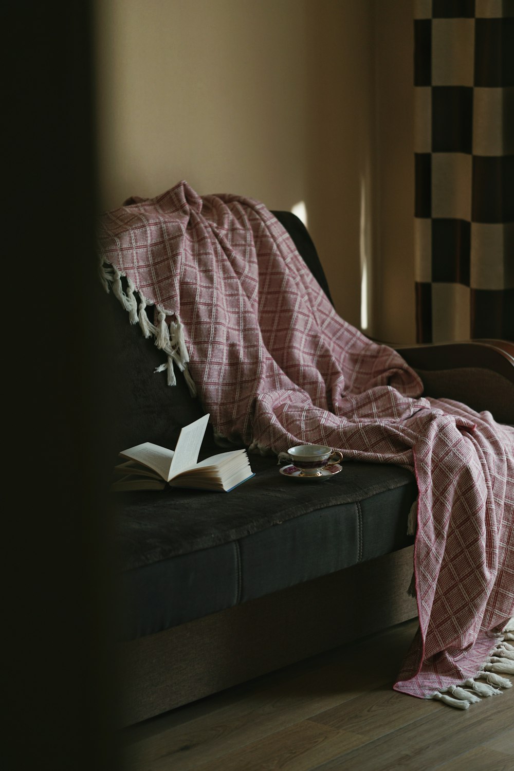 man in black shirt reading book on black couch