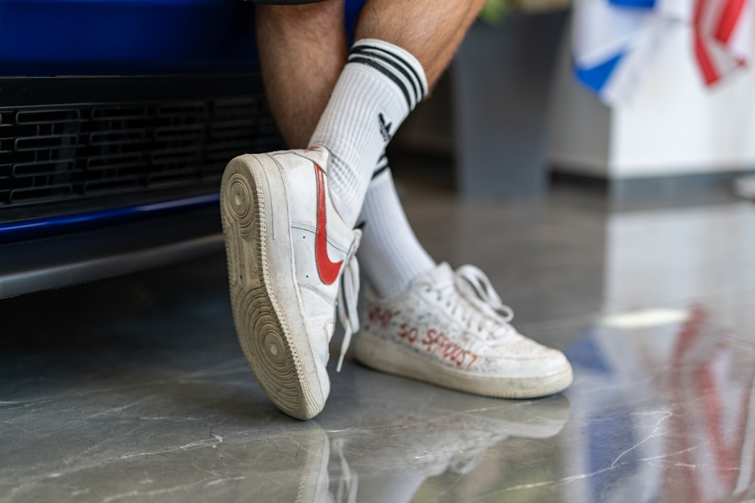 person wearing white nike air force 1 high