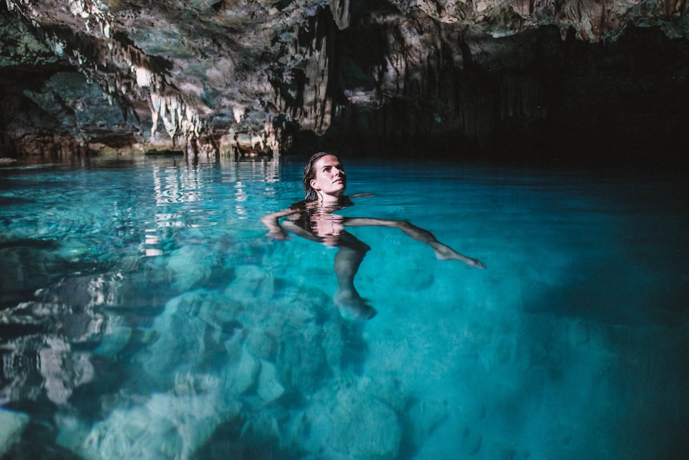 woman in black bikini swimming on water