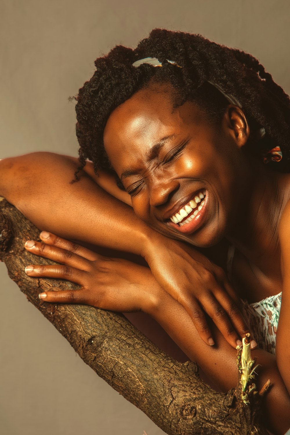 woman in green and white tube top smiling