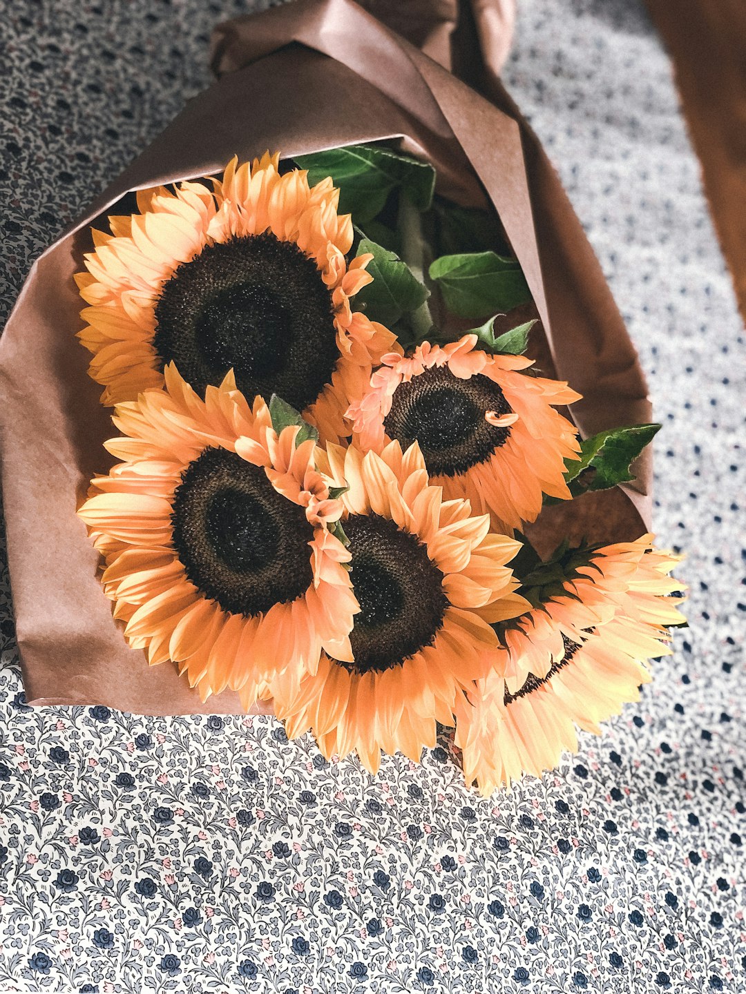 yellow sunflower on brown paper bag