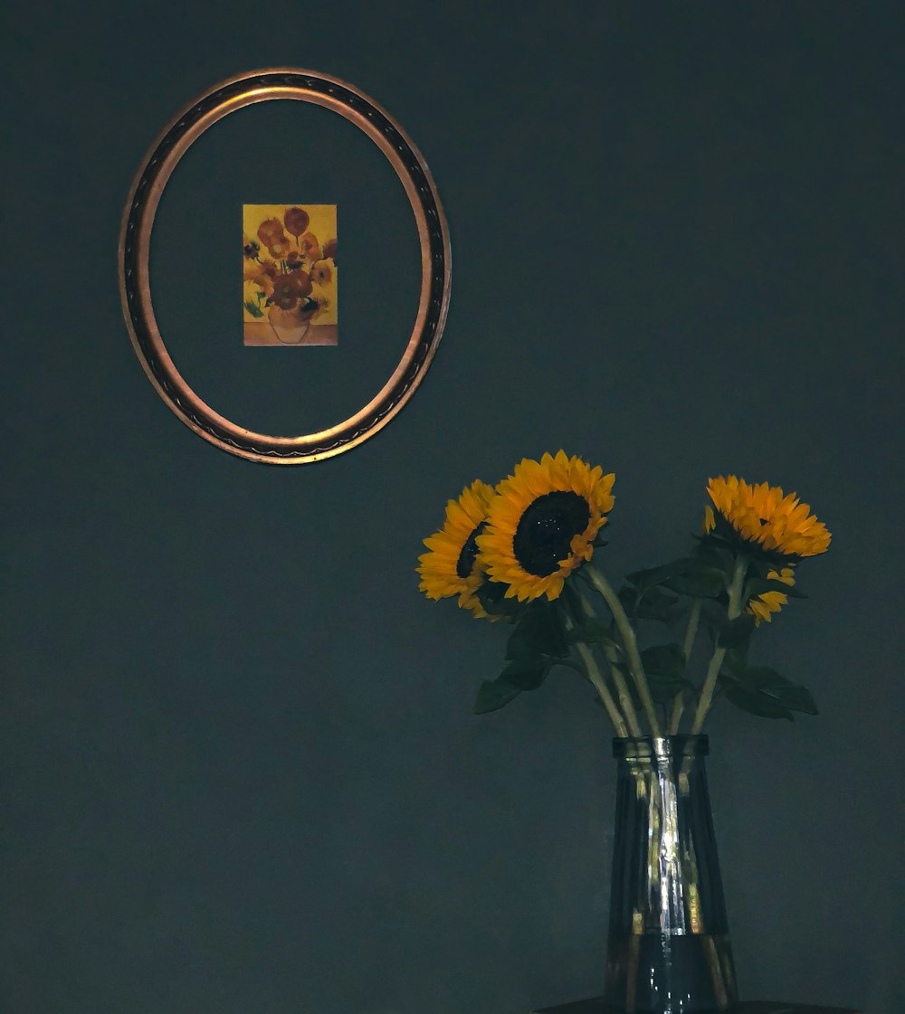 yellow sunflower in clear glass vase