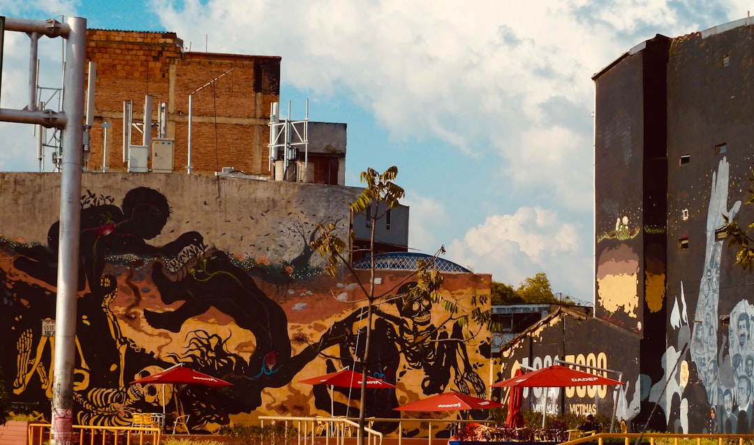 people riding horses near brown concrete building during daytime