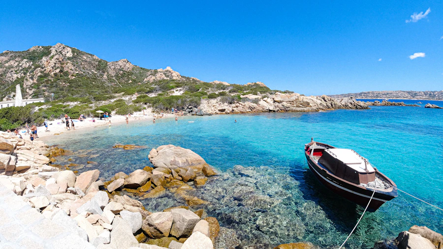 Turquoise cove with a moored boat in Costa Smeralda, Sardinia