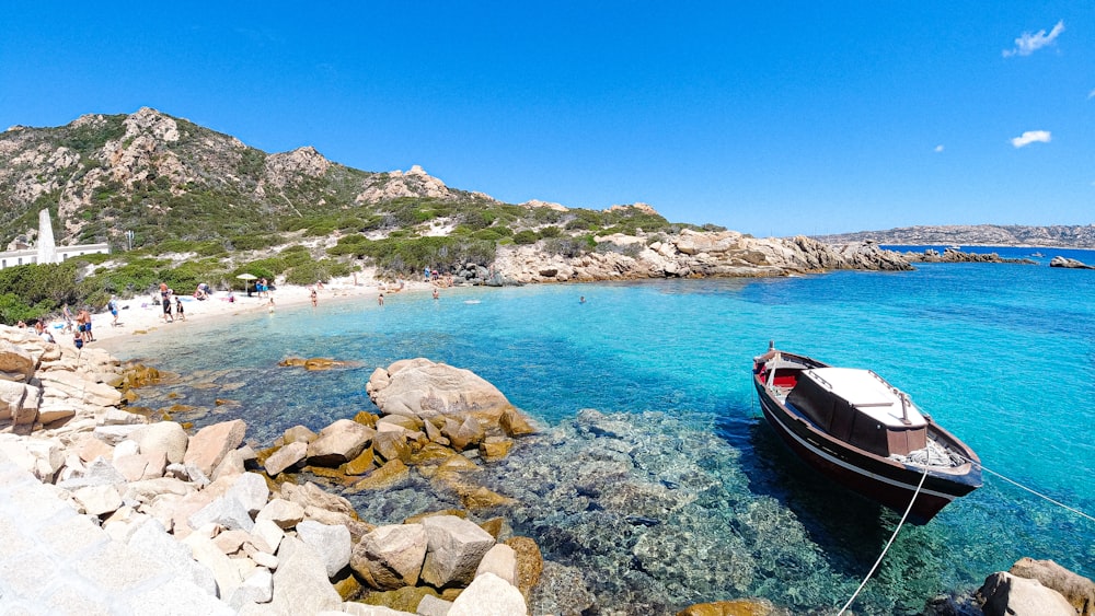 red and white boat on blue sea water during daytime