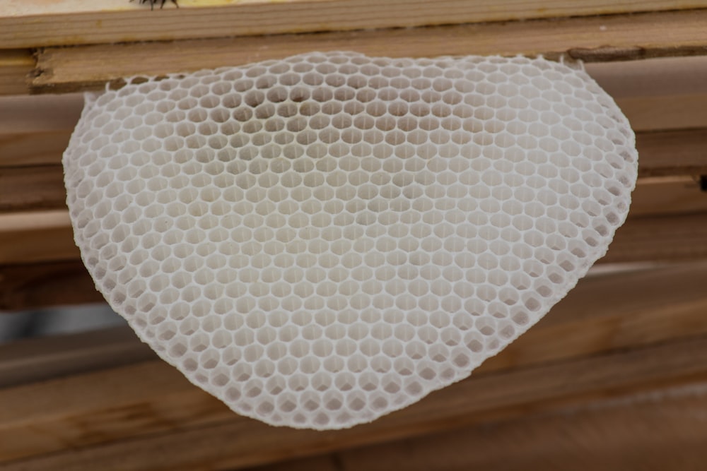 white textile on brown wooden table