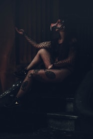 woman in black and white checkered dress sitting on black chair