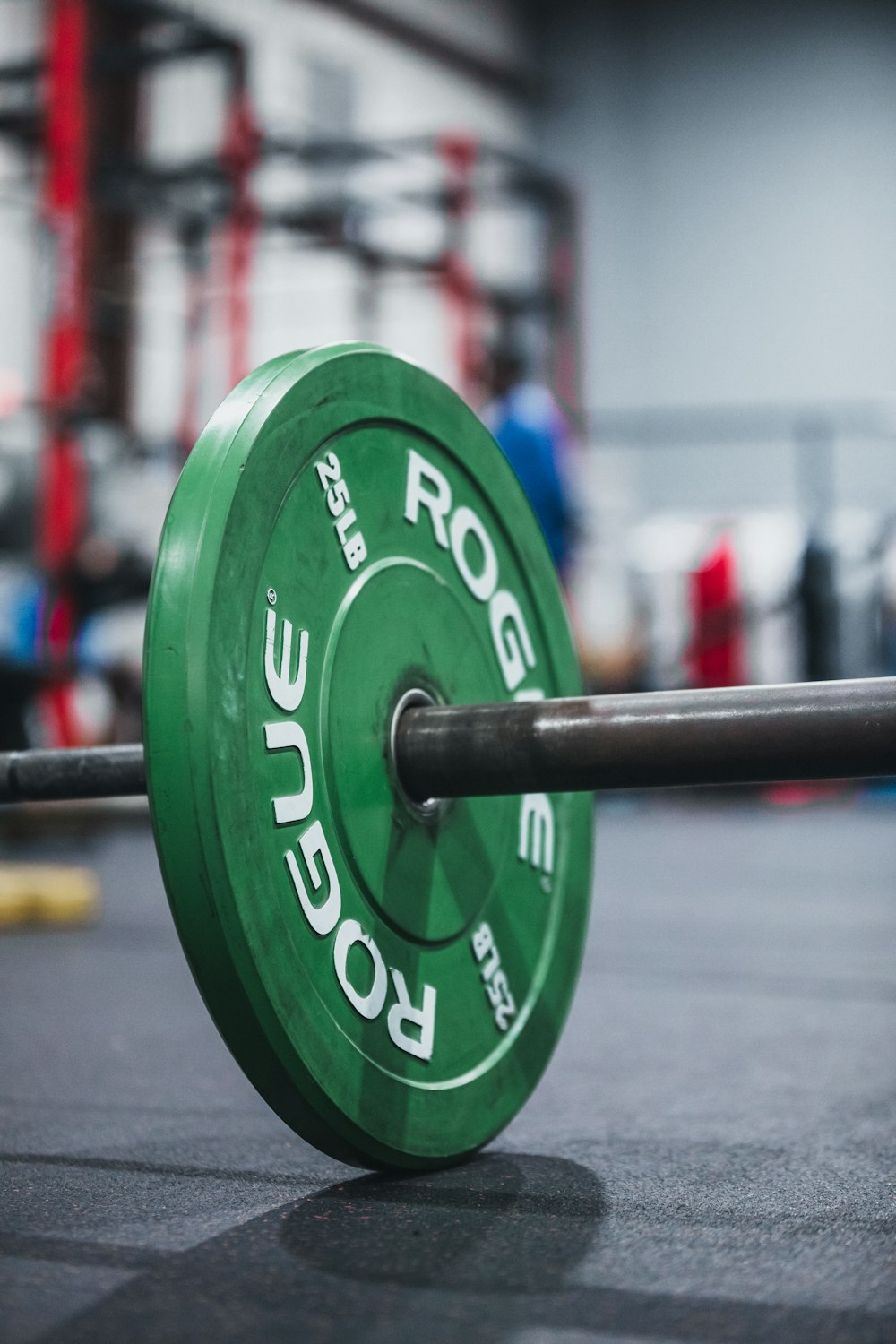 green and black dumbbell on black surface