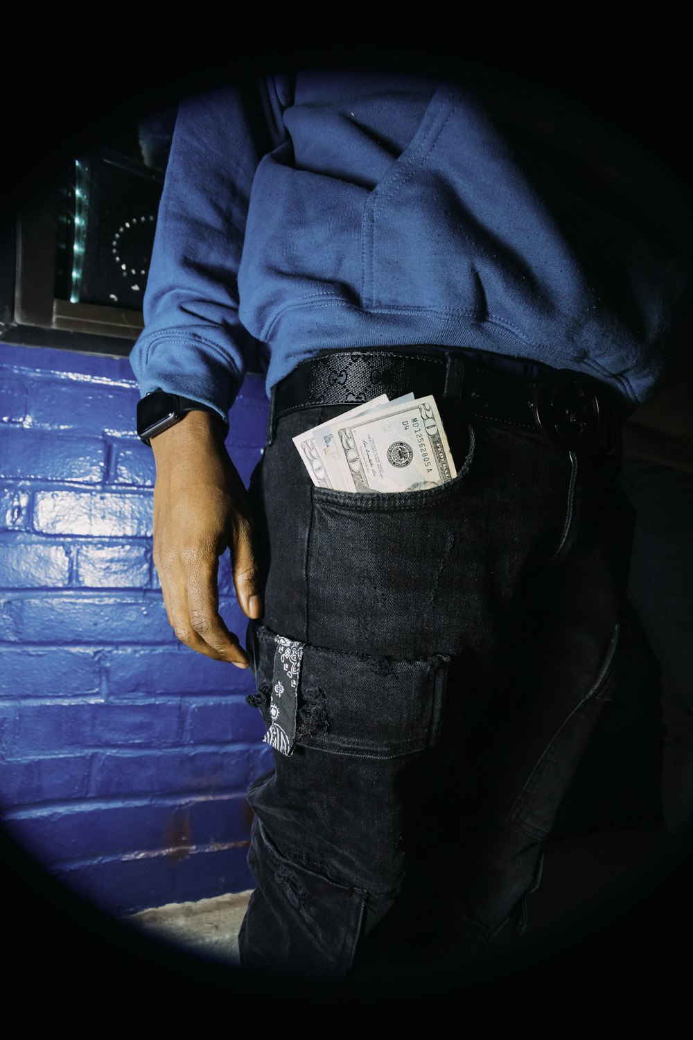 man in blue long sleeve shirt and black denim jeans