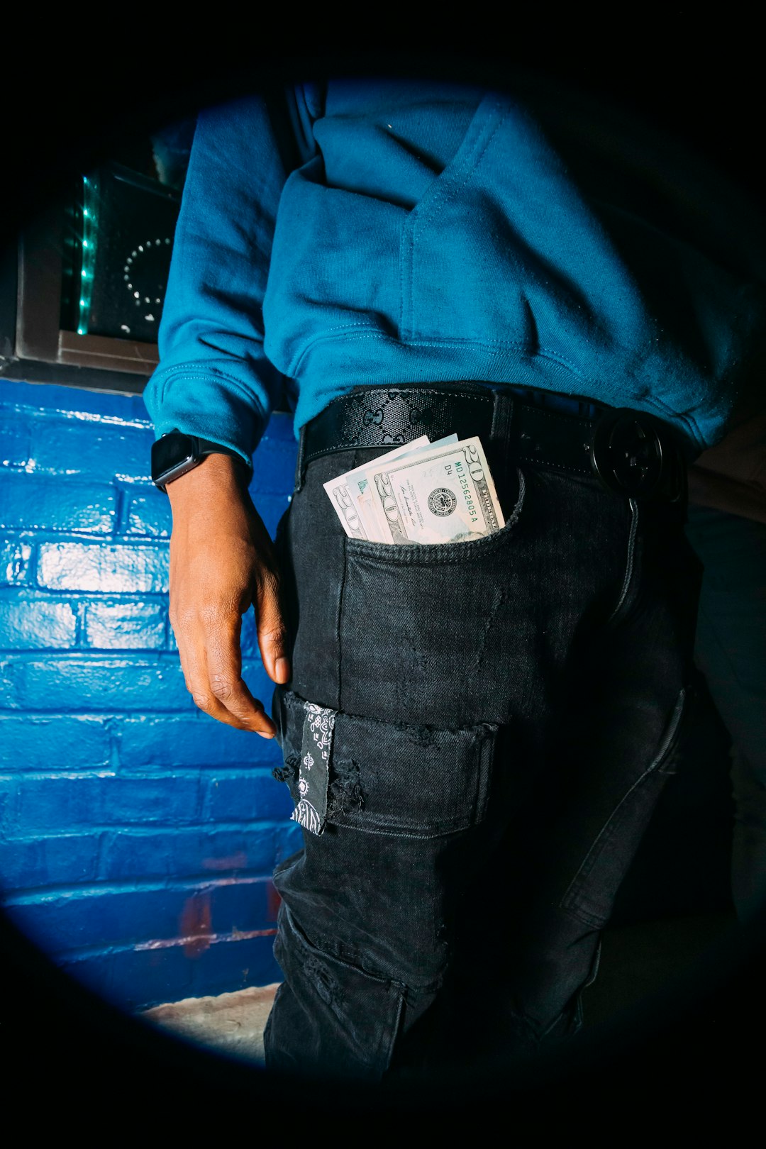 man in blue long sleeve shirt and black denim jeans