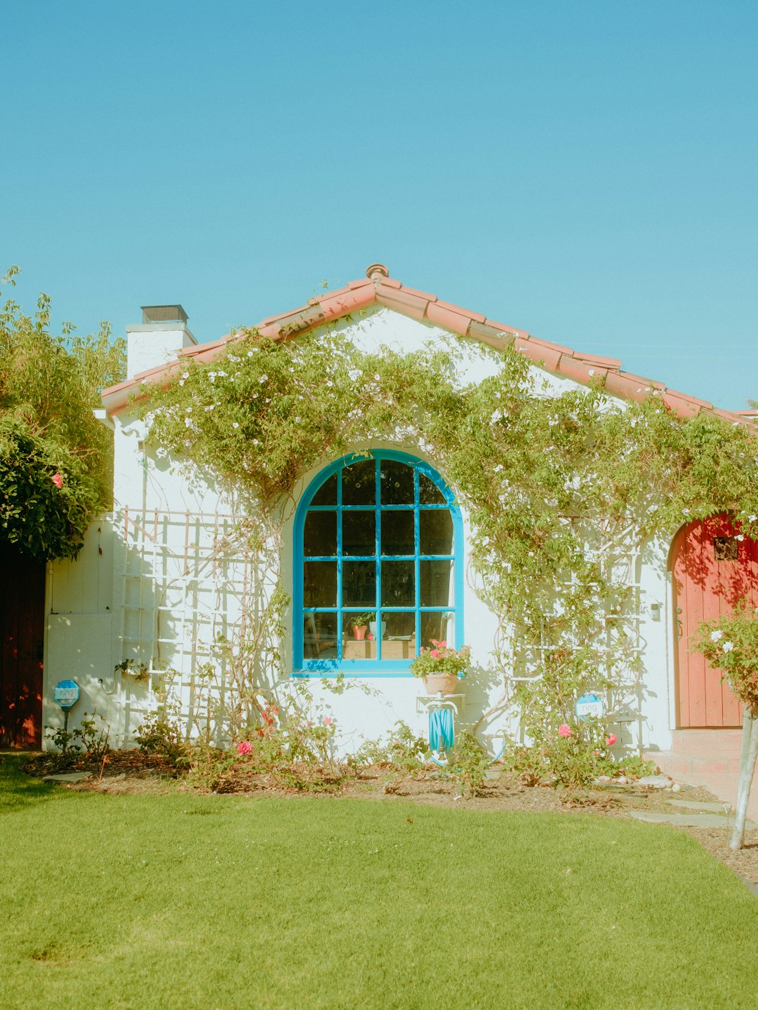 white concrete house with red door