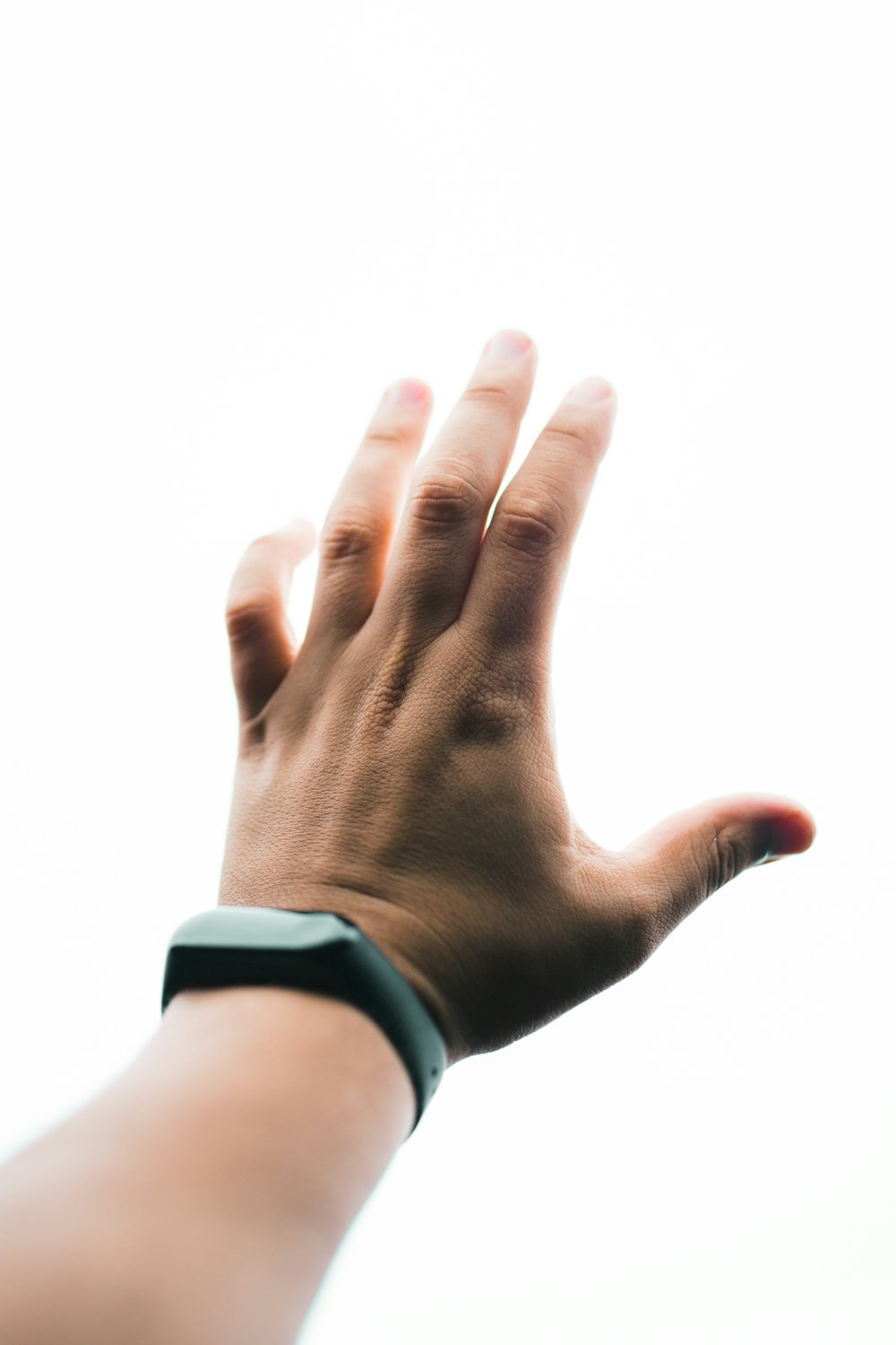 person in black long sleeve shirt showing left hand