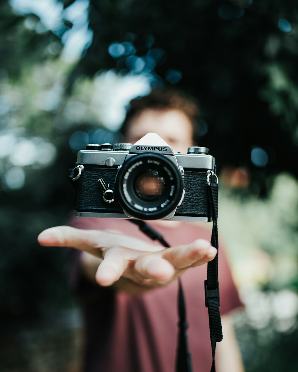 black and silver camera on persons hand