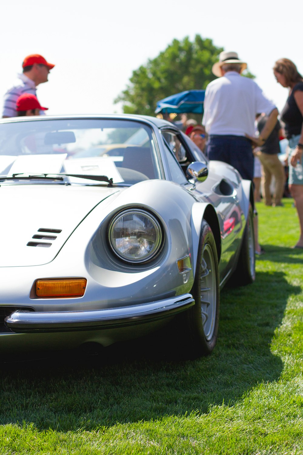 white porsche 911 on green grass field during daytime