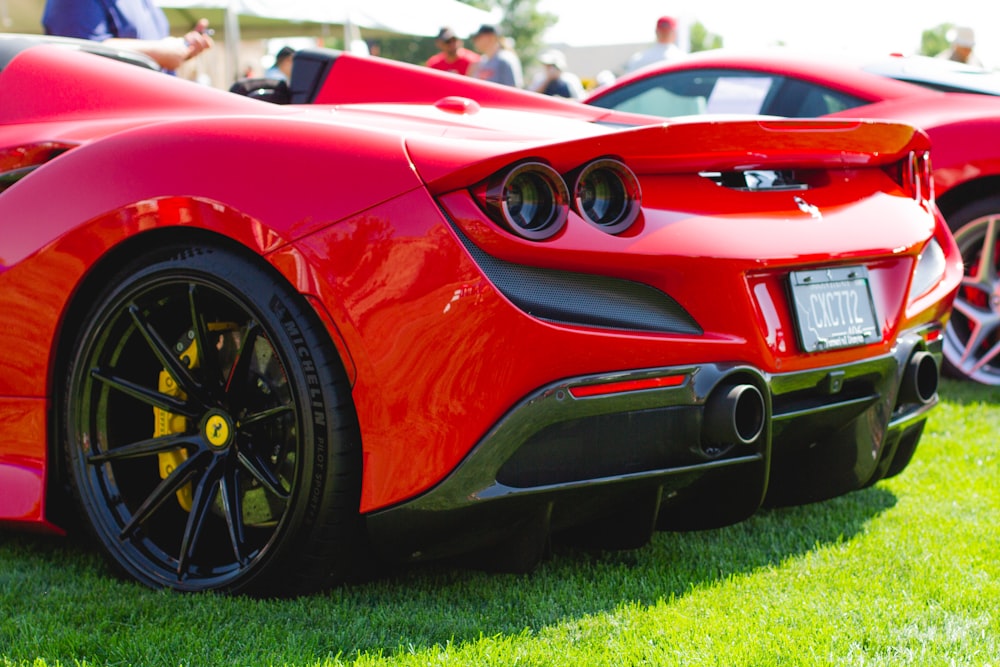 red ferrari 458 italia on green grass field