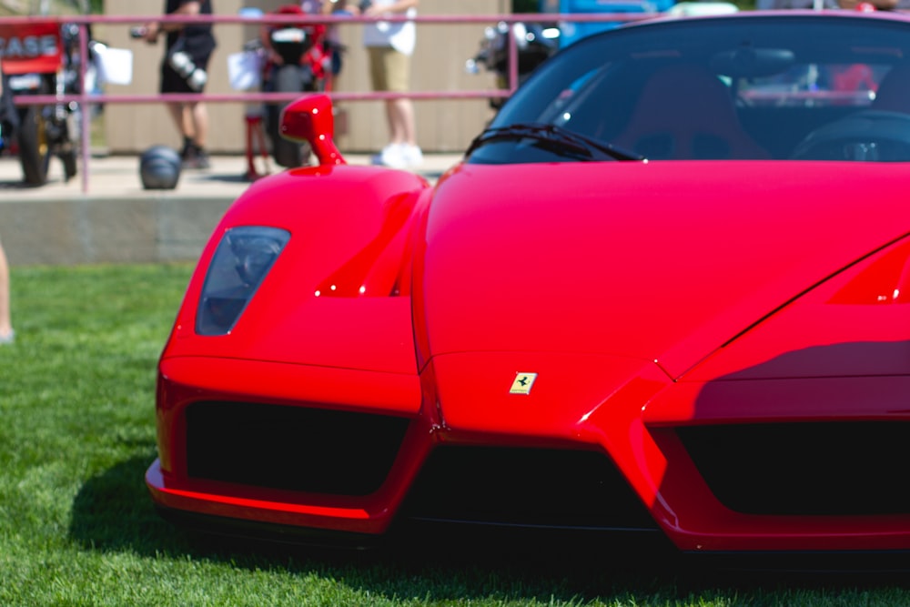 red ferrari 458 italia on green grass field