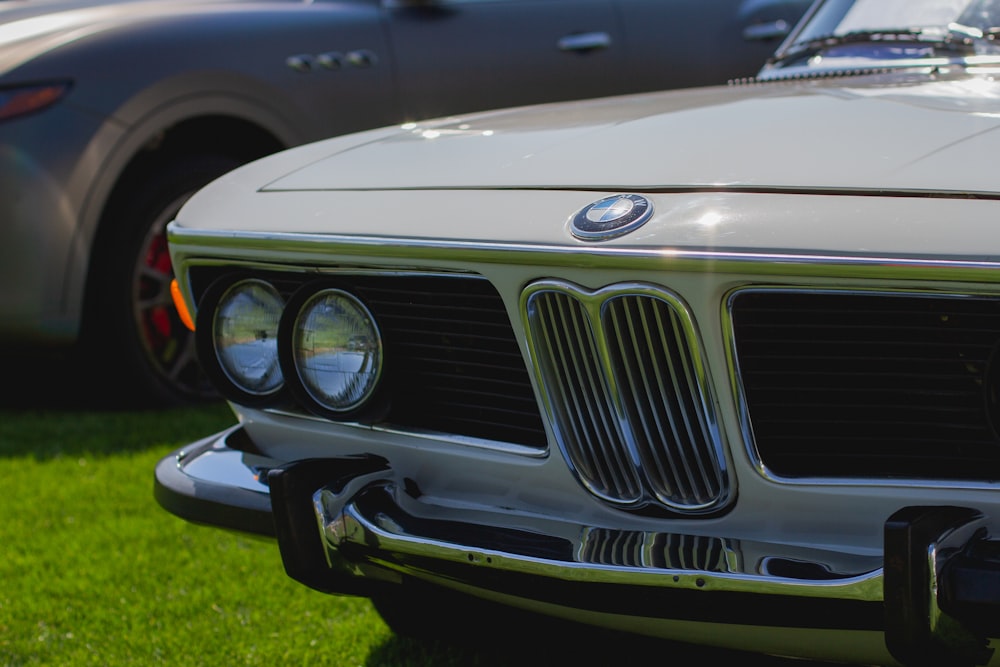 white bmw car on green grass field during daytime