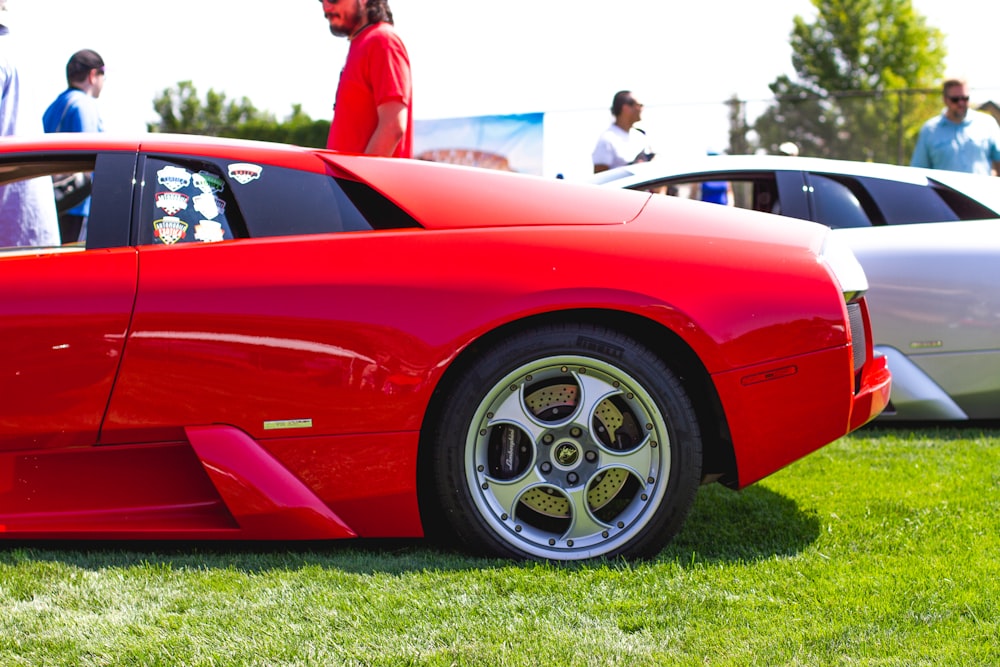 red ferrari 458 italia on green grass field