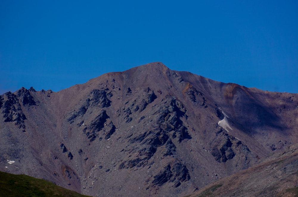 Montaña rocosa gris bajo el cielo azul durante el día