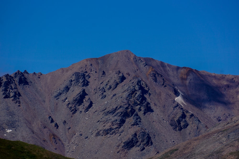 gray rocky mountain under blue sky during daytime