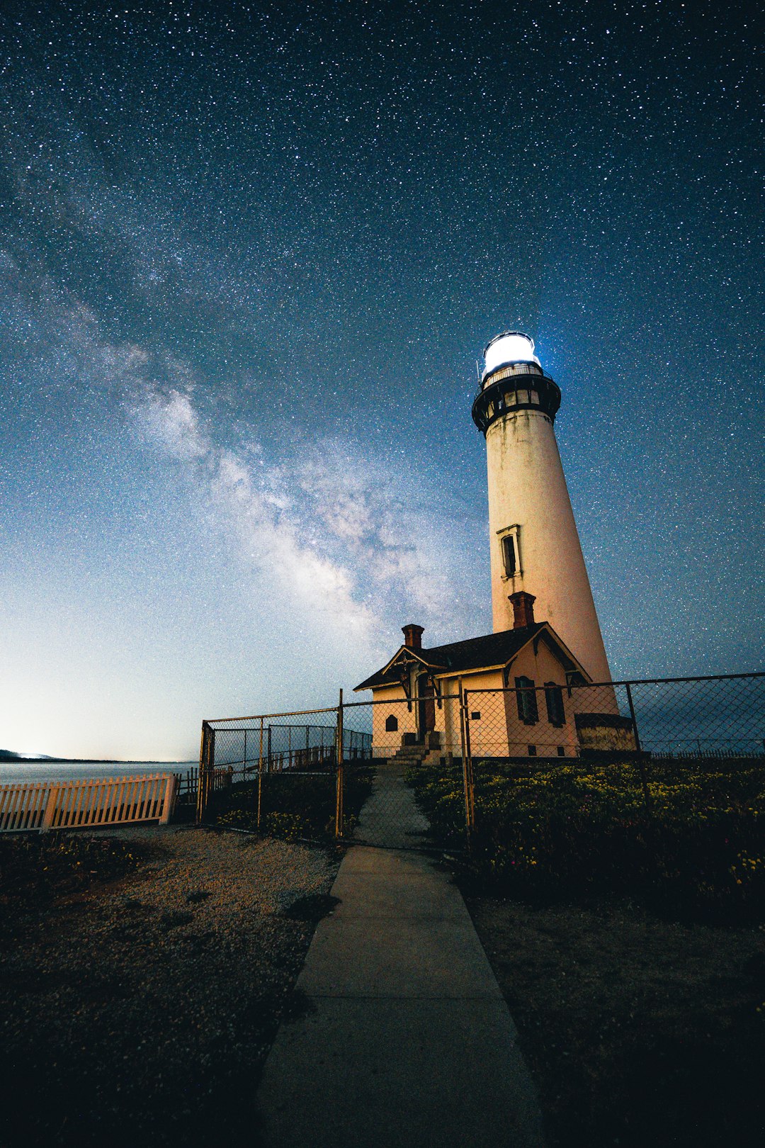 white and black lighthouse under blue sky